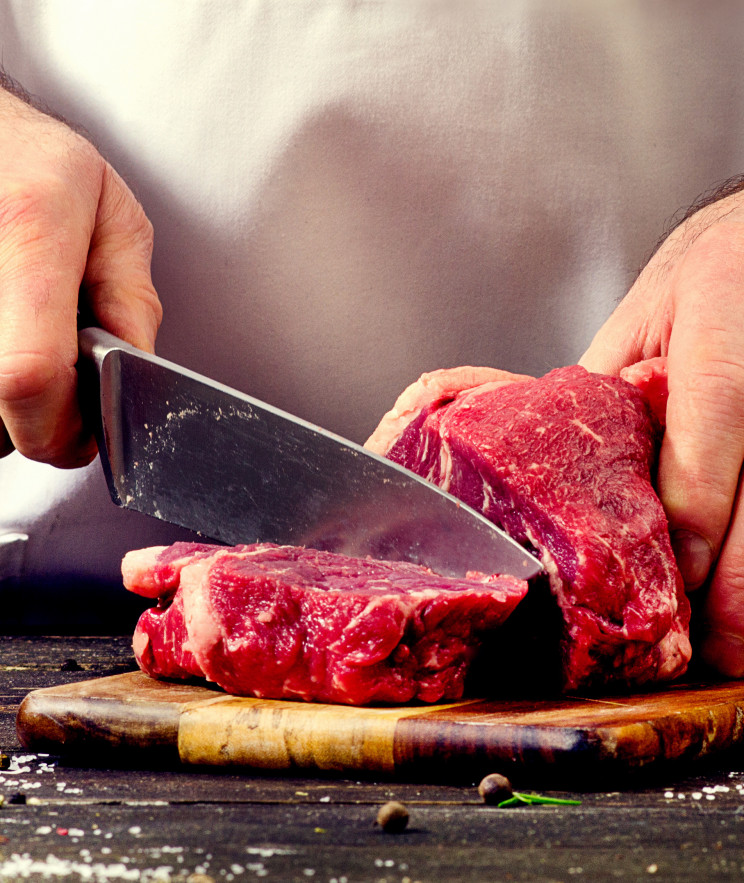 Man cutting beef meat.
